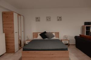a bedroom with a large bed and a couch at Saint Nektarios Ηouse Preveza in Preveza
