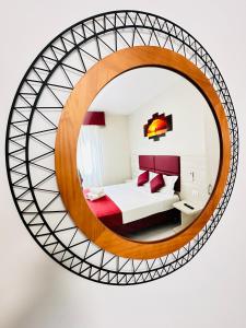 a circular mirror in a hotel room with a bed and a bed at Dream Hub in Mestre