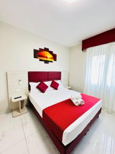 a bedroom with a large bed with a red blanket at Dream Hub in Mestre