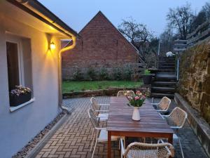 a wooden table and chairs on a patio at FeWo Suhl-Heinrichs, 2 Schlafzimmer, 2 Terrassen in Suhl