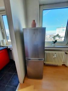 a small refrigerator in a room with a window at City-Wohnung mit Ausblick in Bochum
