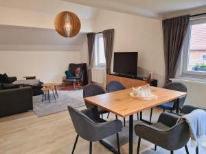 a living room with a table and chairs at Ferienwohnung - Zum alten Fritz - Suhl, 2 Schlafzimmer, 2 Terrassen in Suhl +24 photos