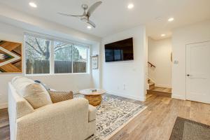 a living room with a couch and a tv at Modern Denver Vacation Rental with Rooftop Deck! in Denver