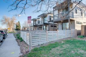 a house with a fence in front of it at Modern Denver Vacation Rental with Rooftop Deck! in Denver