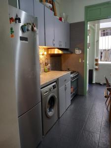 a kitchen with a refrigerator and a washing machine at appartement cosy et chaleureux in Rabat