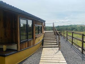 a train is parked on the tracks with a platform at Swallowfield Glamping-Unsinkable in Yeovil