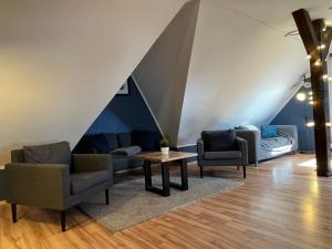 a living room with two chairs and a table at Blue Doors Hostel Altstadt in Rostock