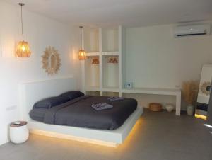 1 dormitorio con 1 cama en una habitación blanca en Crocus Garden en Haad Yao