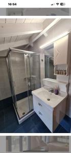 a bathroom with a shower and a white sink at Maria’s family house’s in Elafonisos +43 photos