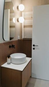 a bathroom with a white sink and a mirror at Terra Apartment in Eretria