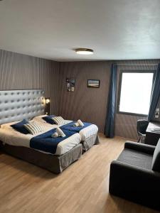 a bedroom with two beds and a couch and a window at Hotel Best Western La Mare Ô Poissons in Ouistreham +37 photos