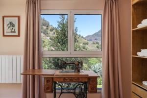 a window with a sink in front of a desk at Casas do Lanço by An Island Apart in São Vicente