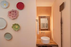 a bathroom with a sink and a mirror on a wall at Casas do Lanço by An Island Apart in São Vicente