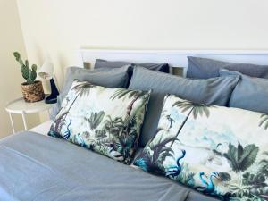 a bed with two pillows on top of it at Amazing Ocean View Apartment in Poris de Abona