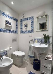 a blue and white bathroom with a toilet and a sink at Semifonte Romantica in Petrognano