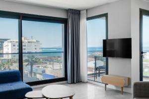 a living room with a view of the ocean at Krem Marin Suites Otel in Cesme