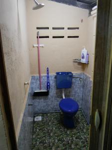 a bathroom with a blue toilet in a room at Warisan Homestay Anjung in Mersing