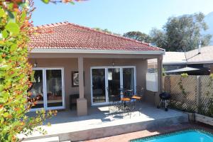 a small house with a patio and a pool at Scenic two bedroom house with splash pool in Cape Town