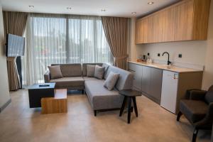 a living room with a couch and a kitchen at ARCADIA of BODRUM in Bodrum City