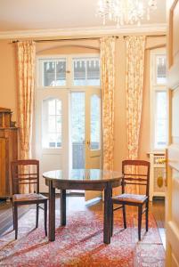 a dining room with a table and two chairs at Villa Pepita in Miedzygorze