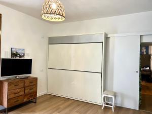 a large sliding door in a room with a television at Appartamento piano terra centro in Viareggio