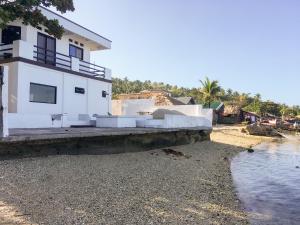 a house on the shore of a beach at Sunset Beach House - Ground Floor in Matnog