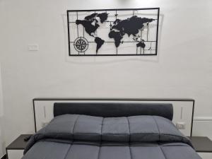 a world map on a wall above a bed at Stylish Apartment Norcia in Norcia