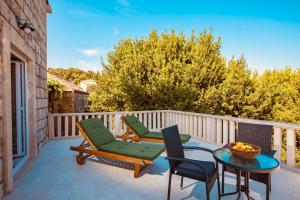 a patio with two chairs and a table on a balcony at Villa Pendo 1450- Full private luxury property in Komaji