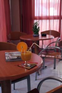 a drink sitting on a table in a restaurant at Hotel Levante in Guardamar del Segura