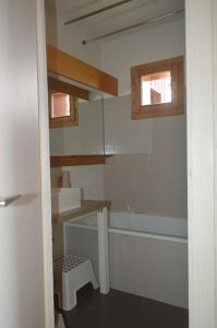 Appartement 7 couchages في Montvalezan: حمام مع حوض وحوض استحمام