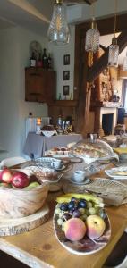a wooden table with plates of food on it at La Dimora dei Baldi - Rooms & Relax in Fagnano Alto