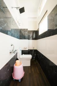 a bathroom with a toilet and a sink at Hotel The Galaxy in Dabok