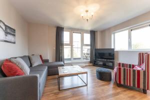 a living room with a couch and a tv at Luxury 2 Bed Apartment Parking by NEC & Solihull in Solihull