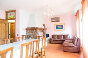 a living room with a table and a couch at Bari Sardo Suite Padronale in Bari Sardo