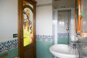a bathroom with a sink and a mirror and a tub at Bari Sardo Suite Padronale in Bari Sardo
