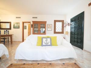 a white couch with yellow pillows in a room at Son Serra II in Son Serra de Marina