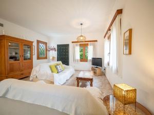 a bedroom with two beds and a tv at Son Serra II in Son Serra de Marina