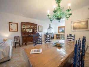 a dining room with a table and a chandelier at Son Serra II in Son Serra de Marina