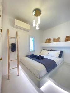 a bedroom with a bed and a ladder in it at Two level house on the Beach in Agios Ioannis Mykonos