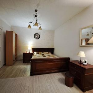 a bedroom with a bed and a clock on the wall at Unique Apartment Centar in Podgorica