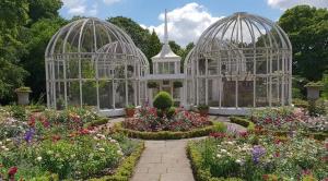 two white gazebos in a garden with flowers at SevenStays Bham city centre 1 bed - free parking in Birmingham