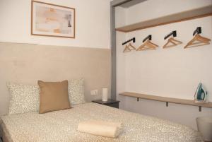 a bedroom with a bed and a shelf with shoes at El Nido in Alicante