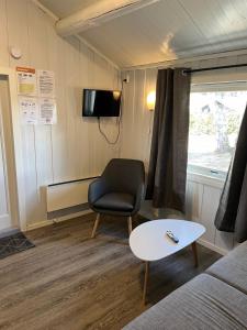 a living room with a chair and a table at Granmo Camping in Oppdal