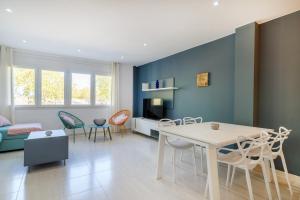 a living room with a table and chairs at Citadel Oliva 4p Roses, Beach & Centre, Private Parking, Terrace in Roses