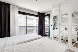 a bedroom with a bed and a window at Krem Marin Suites Otel in Cesme