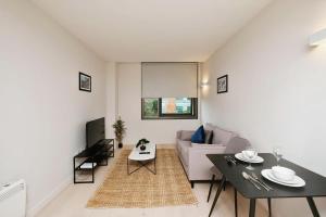 a living room with a couch and a table at Brand New 1 Bed Apt - Seven Stays Bracknell in Bracknell
