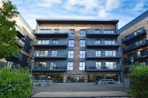 a large building with a courtyard in front of it at Contemporary 2 bedroom apartment - Ashford in Ashford