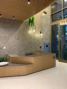 an office lobby with a reception desk and tables at 915 Lux Studio Allianz Park in Sao Paulo
