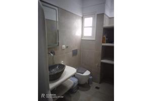 a bathroom with a sink and a toilet at Politimis Studio N3 in Amorgos