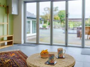 a table with two cups and a bowl on it at 1 bed in Cartmel 85499 in Cark